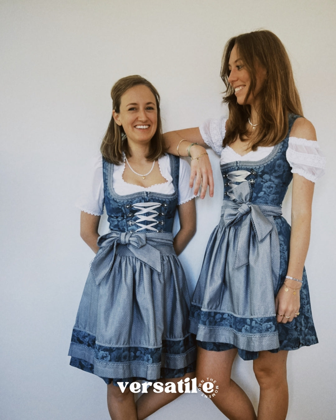 Rent Krüger ZAKIA dirndl in Munich: teal floral jacquard bodice, lace trim, satin ribbon lacing, and shimmering silver apron.