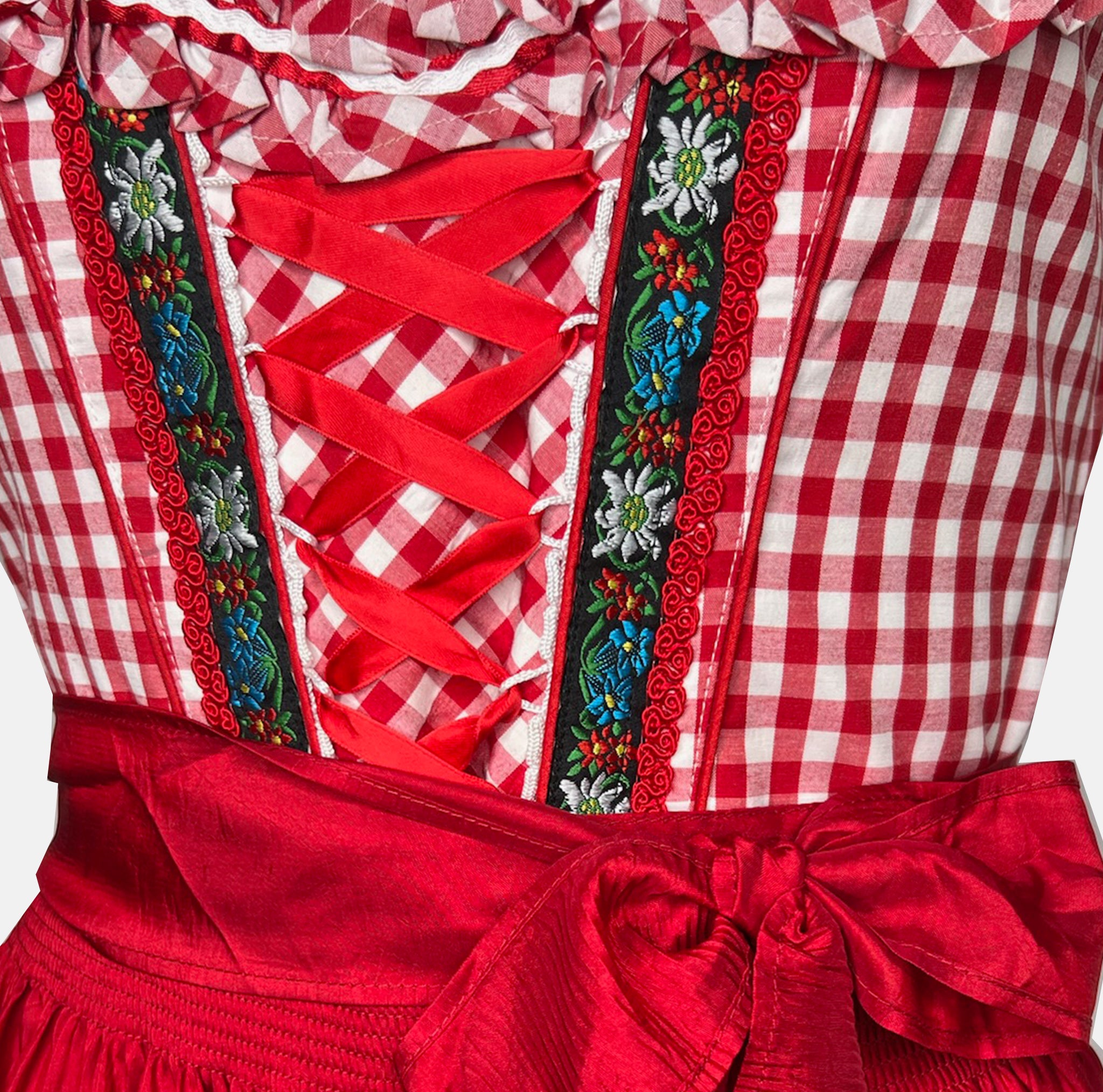 Red Bavarian rental dirndl by La Montana with lace-up bodice, floral trim, and red apron, available at Versatile OTM in Munich, owned by Beer&Pretzel Tours.