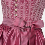 Burgundy Krüger dirndl with floral lace embroidery, satin ribbon bow, and decorative bodice – available for rent at Versatile OTM.
