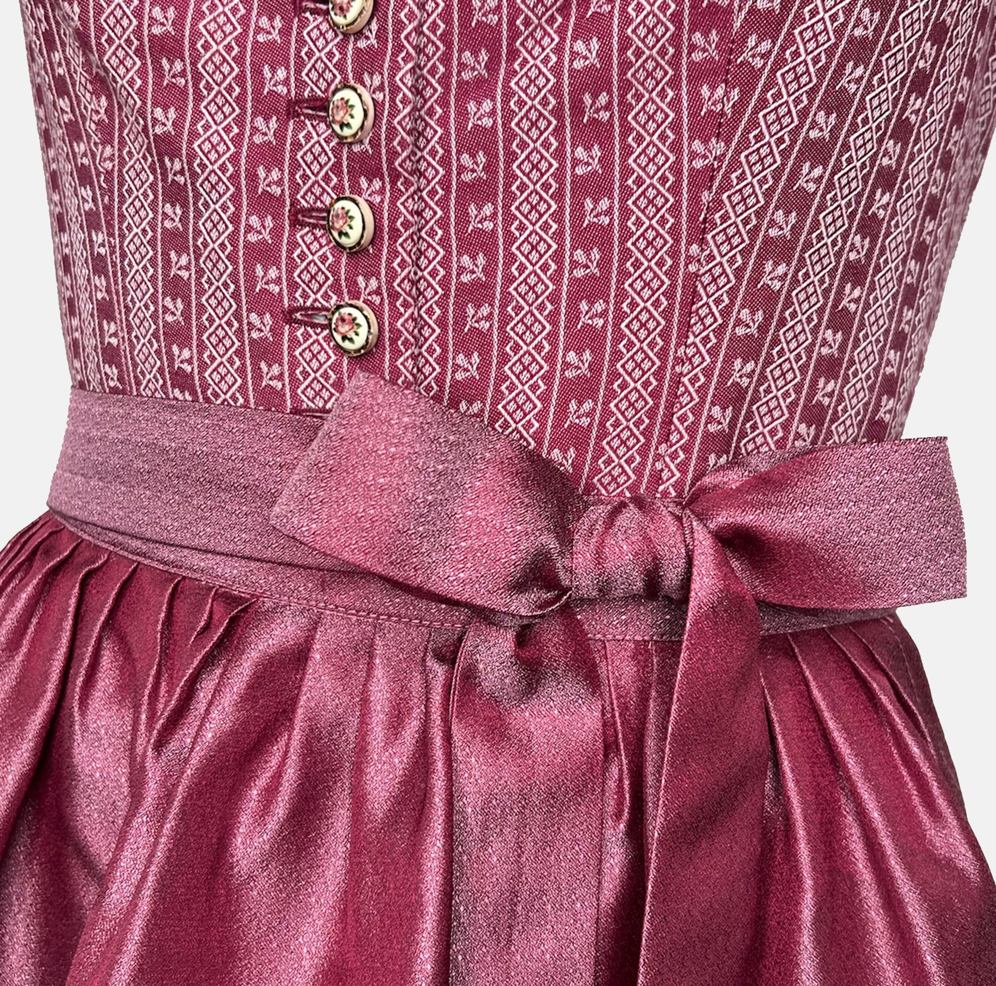 Burgundy Krüger dirndl with floral lace embroidery, satin ribbon bow, and decorative bodice – available for rent at Versatile OTM.