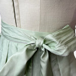 Alpenherz Dirndl Sunny in vibrant apple green with flattering cut and matching apron – fresh, modern, and ideal for festive occasions.