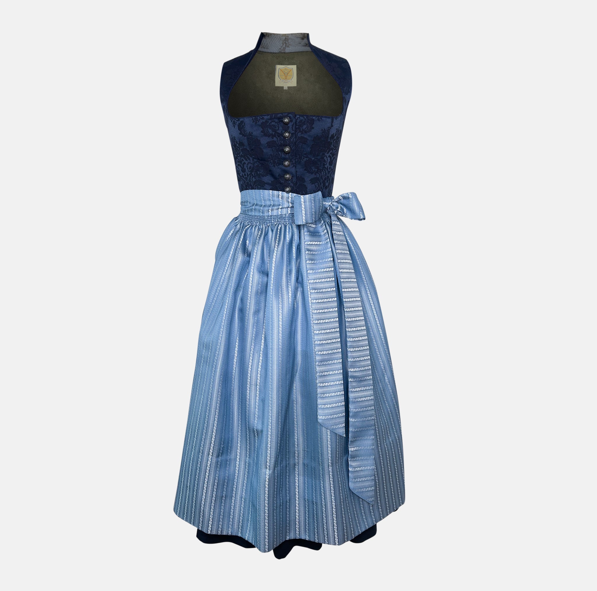Apple of my Eye Dirndl blends timeless tradition with contemporary design. The deep blue jacquard bodice features an elegant floral pattern