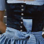 Rent Oktoberfest dirndl in Munich — ‘Apple of My Eye’ with blue jacquard bodice, square neck, silver closures, and sky-blue satin apron accented with woven pattern.