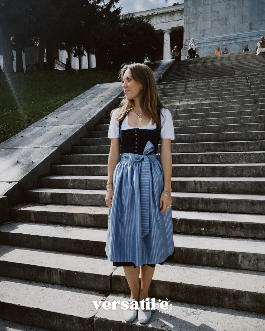 Oktoberfest-ready Dirndl ‘Apple of My Eye’ rental in Munich — navy floral jacquard bodice, delicate silver buttons, light blue striped skirt and apron.