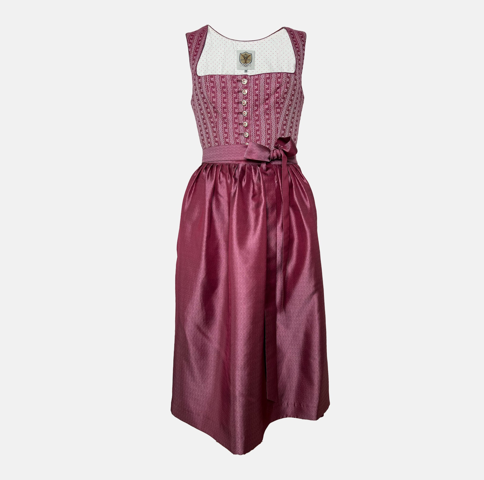 Burgundy Krüger dirndl with floral lace embroidery, satin ribbon bow, and decorative bodice – available for rent at Versatile OTM.