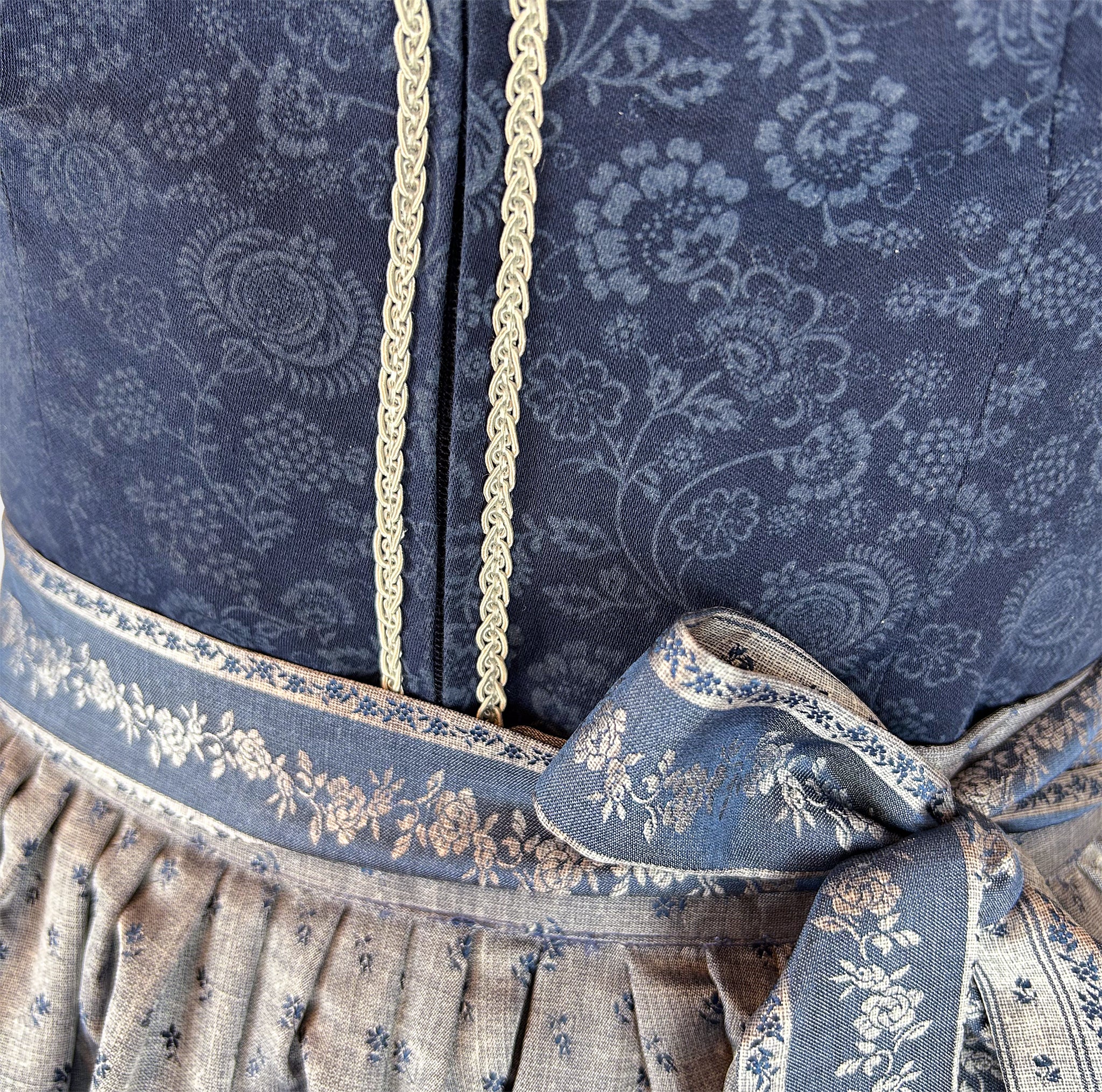 Rent the Berwin & Wolff dirndl—deep navy bodice with floral jacquard, delicate white trim, light blue dotted apron; Versatile rental dirndl