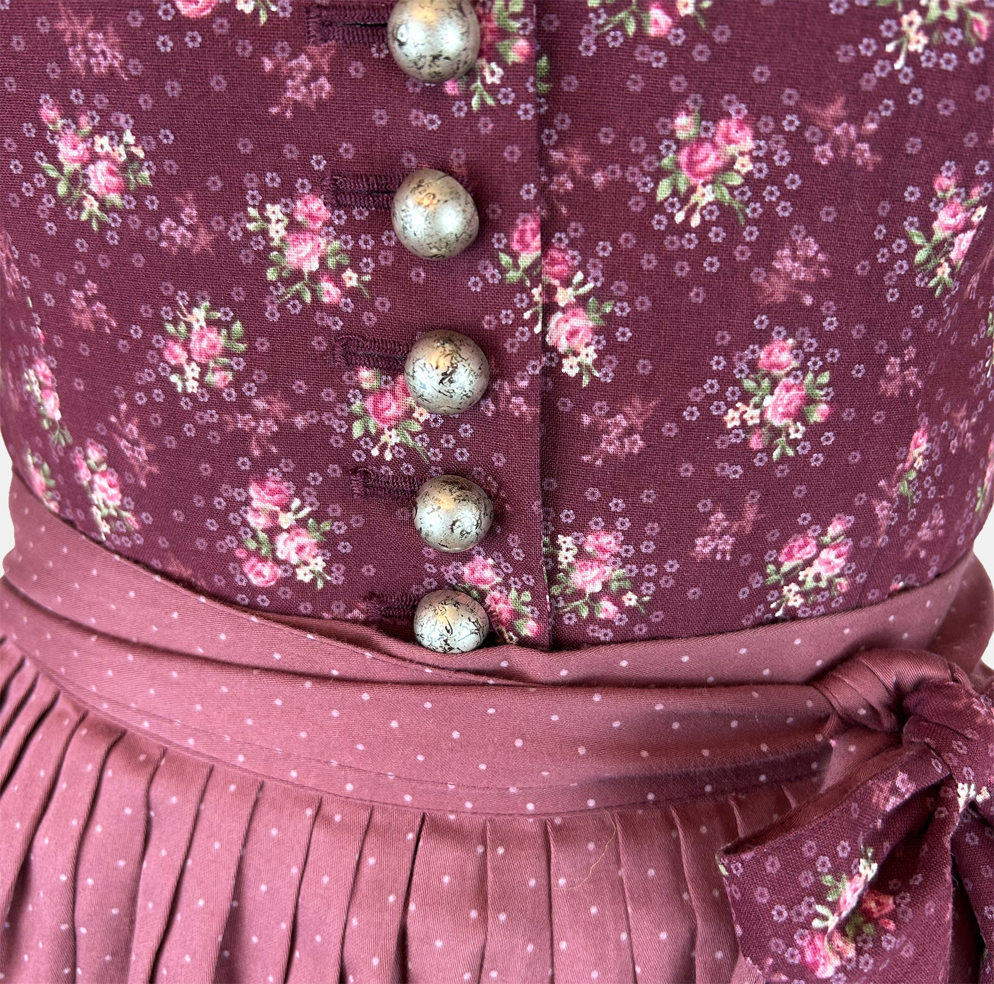 Rent the elegant Berwin & Wolff dirndl dress—wine-red floral pattern, dotted skirt, slim floral belt; rental dirndl