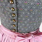 Traditional Berwin & Wolff Dirndl with a grey bodice and pink apron, available to rent at Versatile OTM.