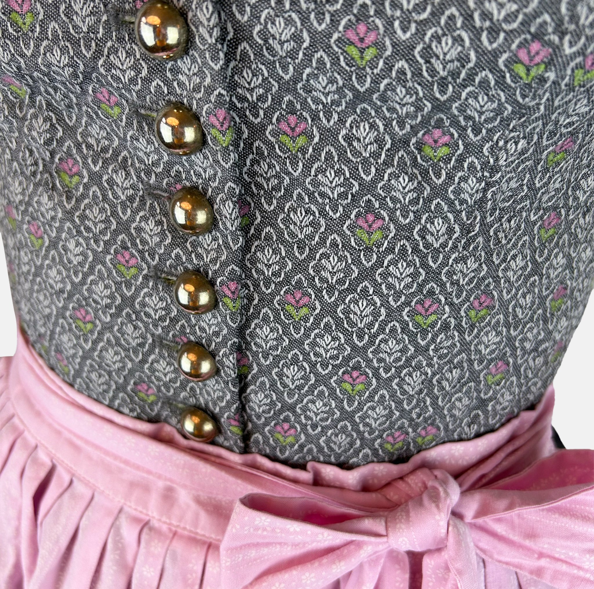 Traditional Berwin & Wolff Dirndl with a grey bodice and pink apron, available to rent at Versatile OTM.