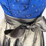 Berwin & Wolff Dirndl with royal blue embroidered bodice and shiny olive-green apron, available to rent at Versatile OTM.