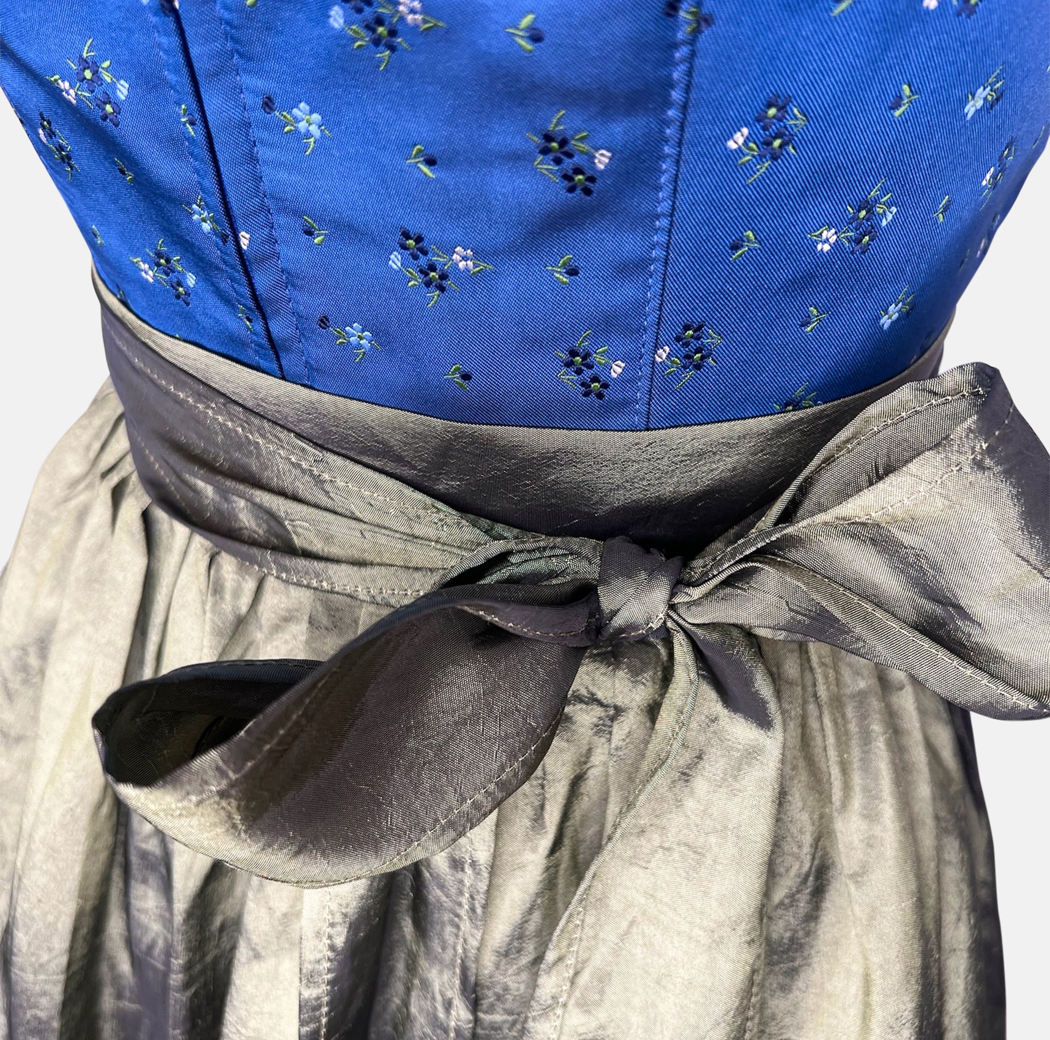 Berwin & Wolff Dirndl with royal blue embroidered bodice and shiny olive-green apron, available to rent at Versatile OTM.