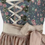 Blue floral dirndl with shimmering rosé apron and vintage-style details – perfect for fashionable Oktoberfest moments or elegant Bavarian events.