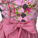 Berwin & Wolff dirndl in rose pink with satin ribbon lace bodice and matching apron—60 cm midi length, elegant and feminine, for Oktoberfest rental via Versatile.