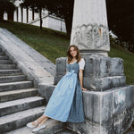 Berwin & Wolff rental dirndl in Munich with green and blue plaid bodice and light blue floral apron—perfect Oktoberfest dress hire.