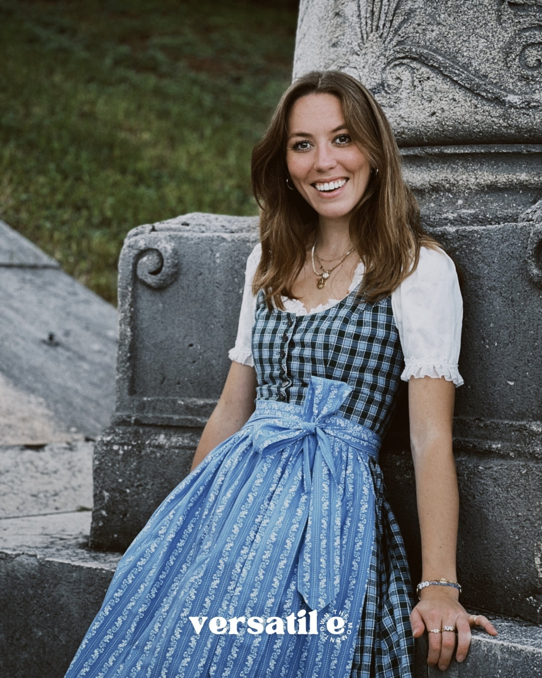 Rent a Berwin & Wolff Bavarian dirndl with ornate silver buttons and romantic light blue apron, available in Munich for Oktoberfest.