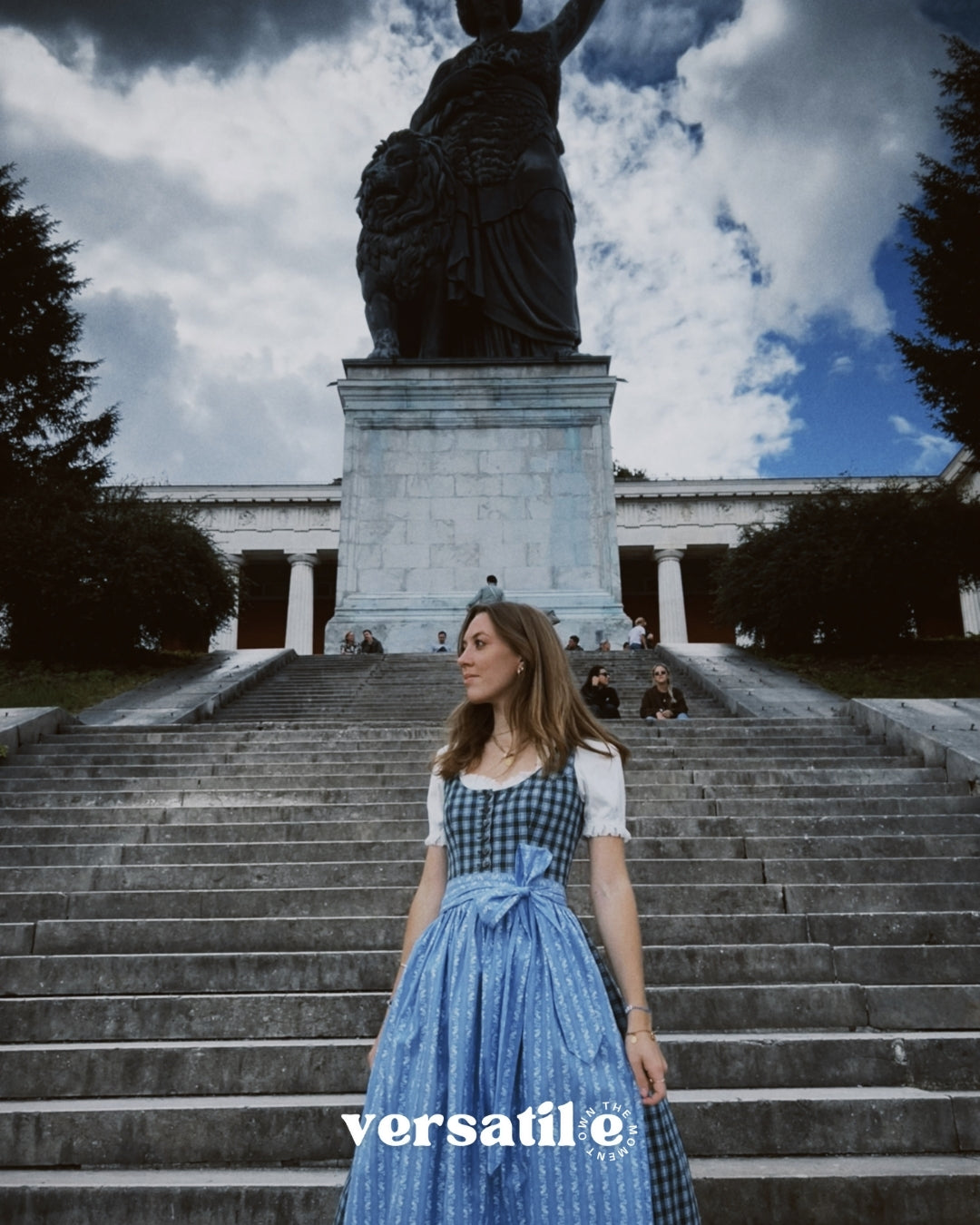Bavarian Berwin & Wolff dirndl rental with structured plaid bodice and delicate blue floral apron, perfect for Oktoberfest in Munich.