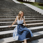 Oktoberfest-ready Berwin & Wolff dirndl in navy and white stripes with button closure and 75 cm skirt, available for rental at Versatile OTM Munich.