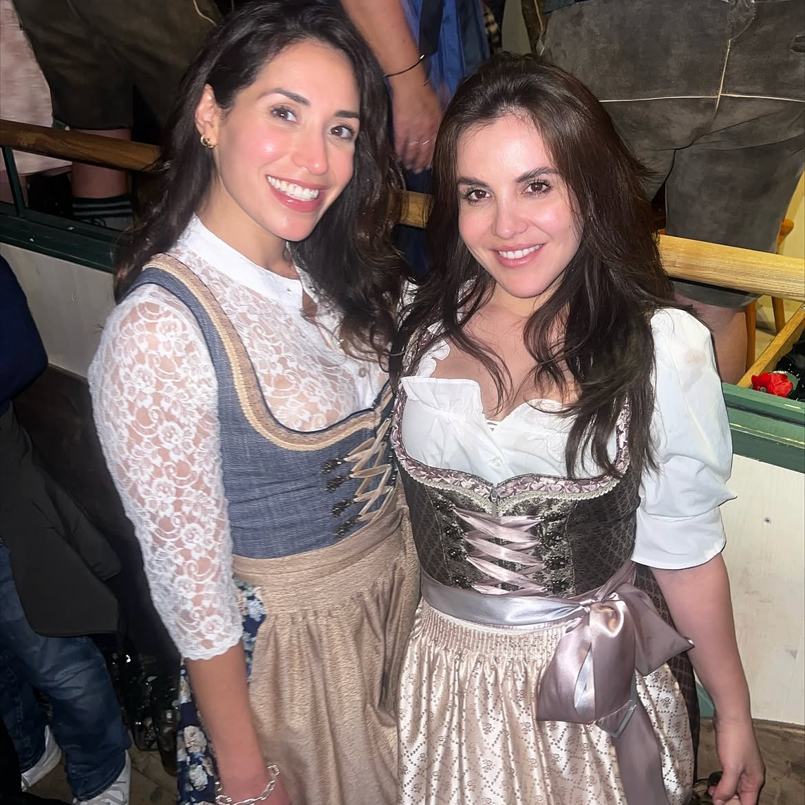 Krüger Dirndl cheeky rented Dirndls for Oktoberfest on Versatile OTM. Two women wearing different style Krüger Dirndl for rental on Versatile otm 
