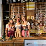 Three women wearing traditional German Dirndl dresses one bestseller Dirndl Krueger Dirndl. Ready to rent on Versatile OTM for Oktoberfest 