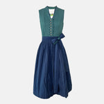 Dollar Tracht Dirndl with high-necked green bodice and deep blue patterned apron, available to rent at Versatile OTM.