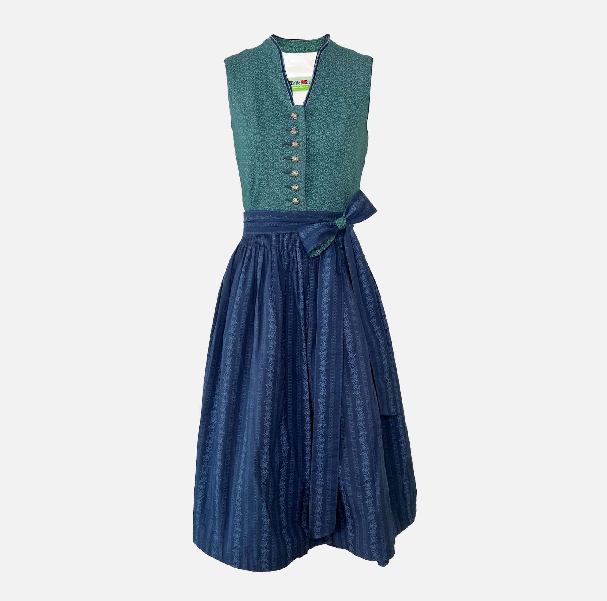Dollar Tracht Dirndl with high-necked green bodice and deep blue patterned apron, available to rent at Versatile OTM.