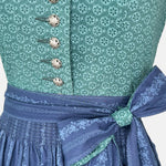 Dollar Tracht Dirndl with high-necked green bodice and deep blue patterned apron, available to rent at Versatile OTM.