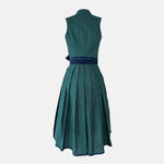 Dollar Tracht Dirndl with high-necked green bodice and deep blue patterned apron, available to rent at Versatile OTM.