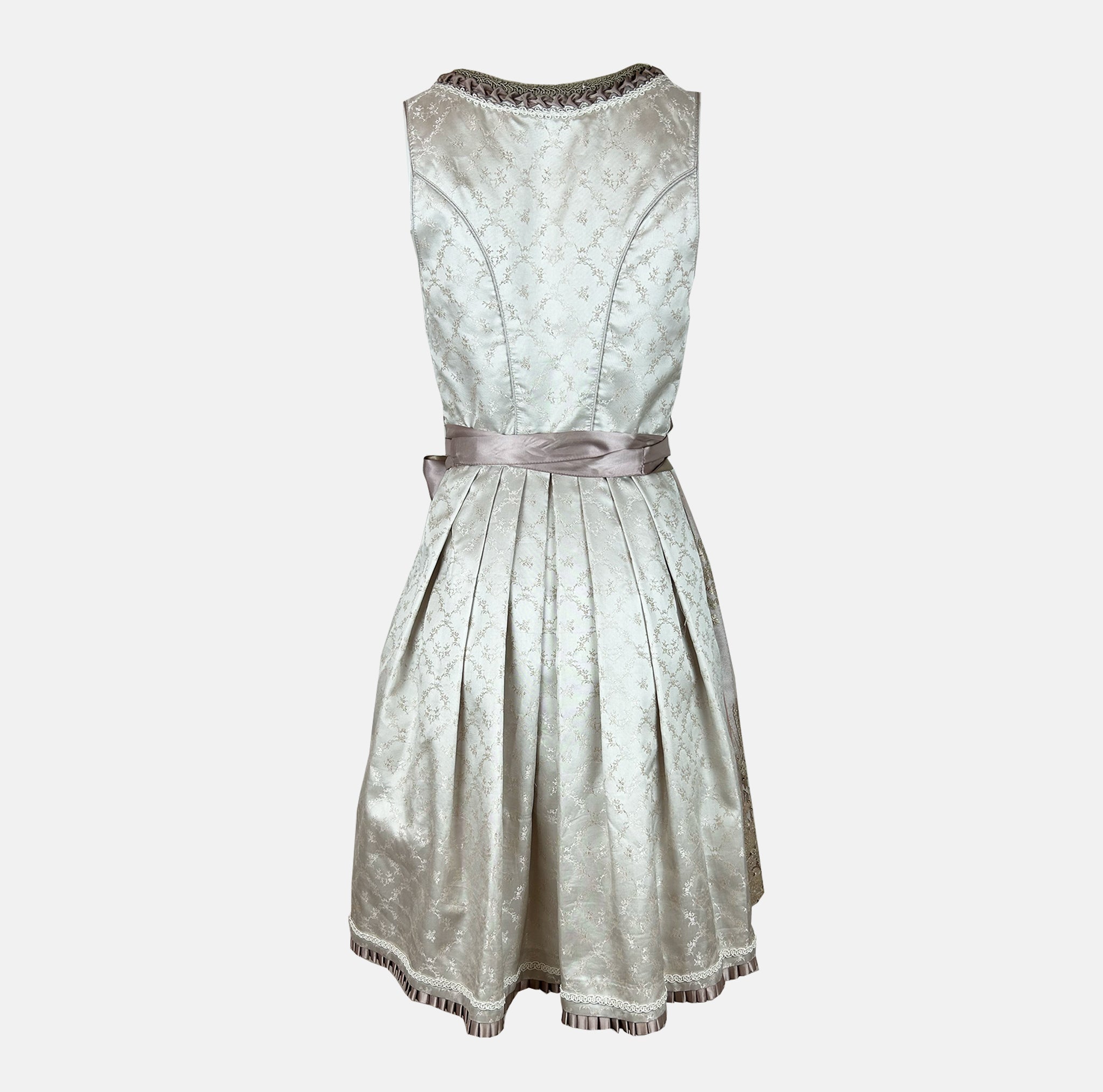 Close-up of a Krüger Dirndl featuring an ivory bodice with silver ribbon lacing and a gold embroidered apron. Skirt length 60cm. Elegant and luxurious.