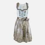Close-up of a Krüger Dirndl featuring an ivory bodice with silver ribbon lacing and a gold embroidered apron. Skirt length 60cm. Elegant and luxurious.