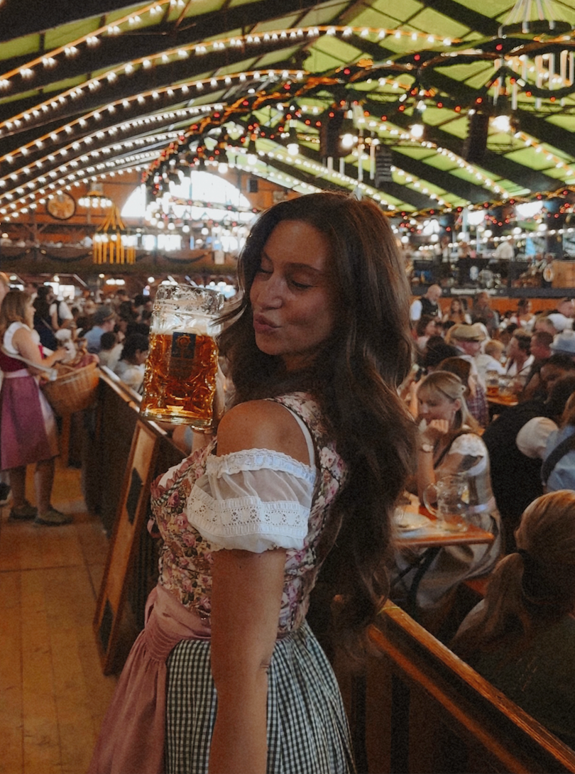 Girl wearing a traditional rental dirndl. German Oktoberfest cheeky dress flower dream, ready to rend for Oktoberfest on Versatile OTM