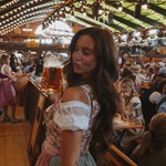 Girl wearing a traditional rental dirndl. German Oktoberfest cheeky dress flower dream, ready to rend for Oktoberfest on Versatile OTM