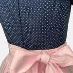 Elegant handmade Dirndl with navy top and soft pink apron—premium Bavarian dress rental from Versatile OTM in Munich