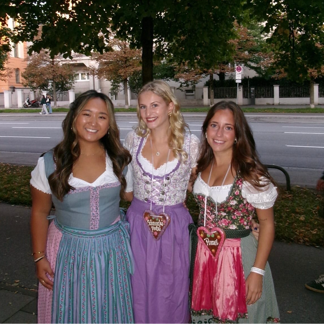 Three women wearing traditional German Dirndl dresses one bestseller Dirndl Krueger Dirndl. Ready to rent on Versatile OTM for Oktoberfest 
