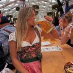 A woman in a traditional German dirndl Krüger Flower Dream Dirndl. Dirndl Ready to rent on Versatile OTM for Oktoberfest