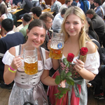 Two women posing in with traditional German Krueger Dirnld dresses at Oktoberfest. Dirndl ready to rent on Versatile OTM 