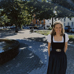 Gottseidank Monika dirndl rental in Munich – structured black pleated bodice with covered buttons, indigo denim skirt, square neckline; ideal Oktoberfest dress.