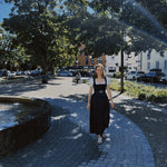 Munich rental dirndl – Gottseidank Monika with structured black pleated bodice, square neckline, and knee-length indigo denim skirt; great for Oktoberfest.