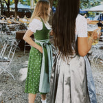 Two women in traditional German dirndls standing outdoors with versatile Dirndls rented Hammerschmid Dirndl 
