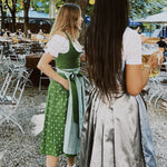 Two women in traditional German dirndls standing outdoors with versatile Dirndls rented Hammerschmid Dirndl 