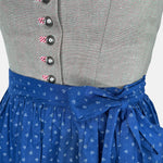 A traditional Hammerschmid Dirndl dress featuring a blue skirt with a floral pattern and a beige bodice with embroider