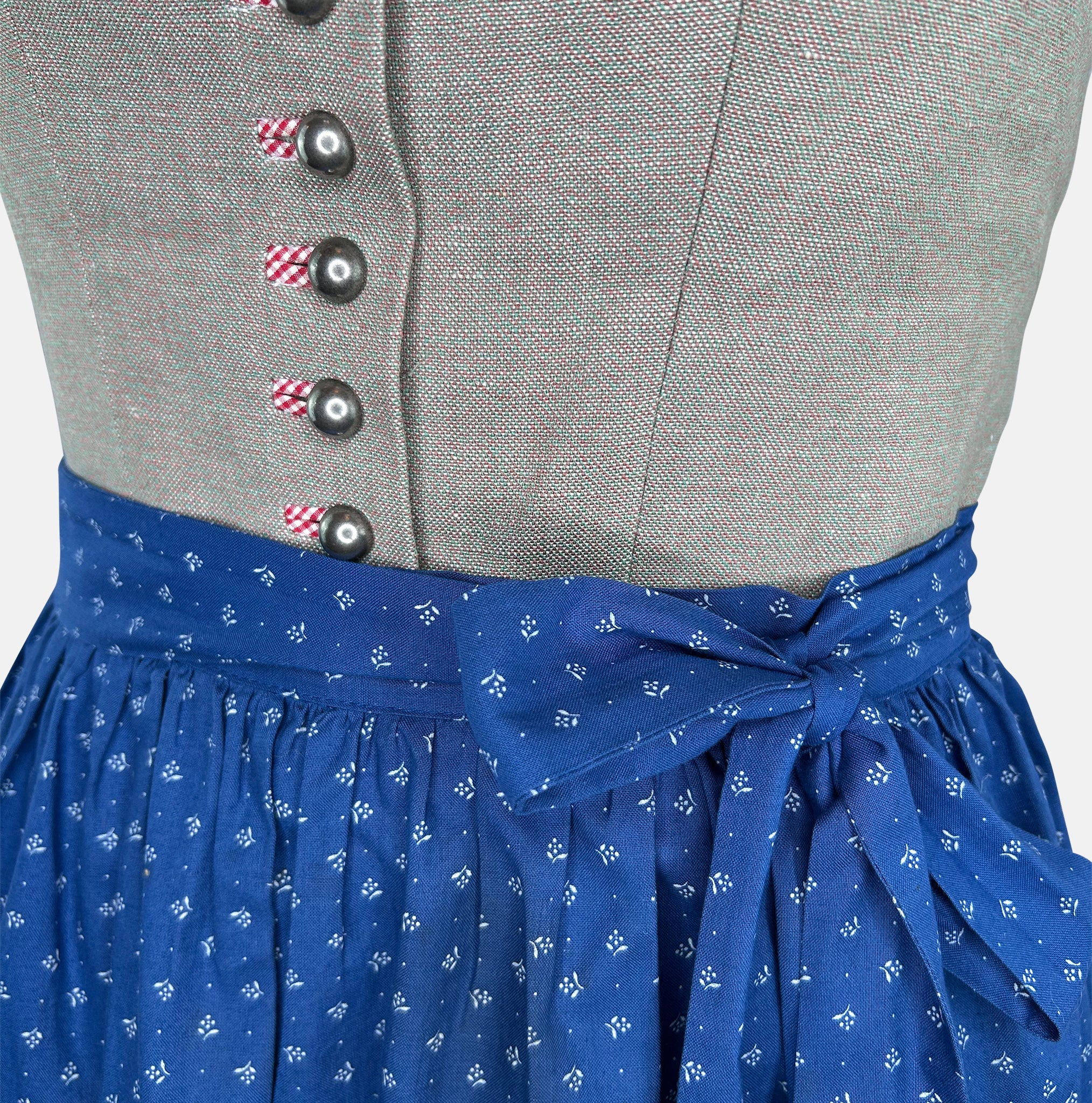 A traditional Hammerschmid Dirndl dress featuring a blue skirt with a floral pattern and a beige bodice with embroider