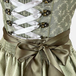Green Krüger dirndl with lace-up bodice and 60 cm skirt – modern, stylish, and available for rent via Versatile.
