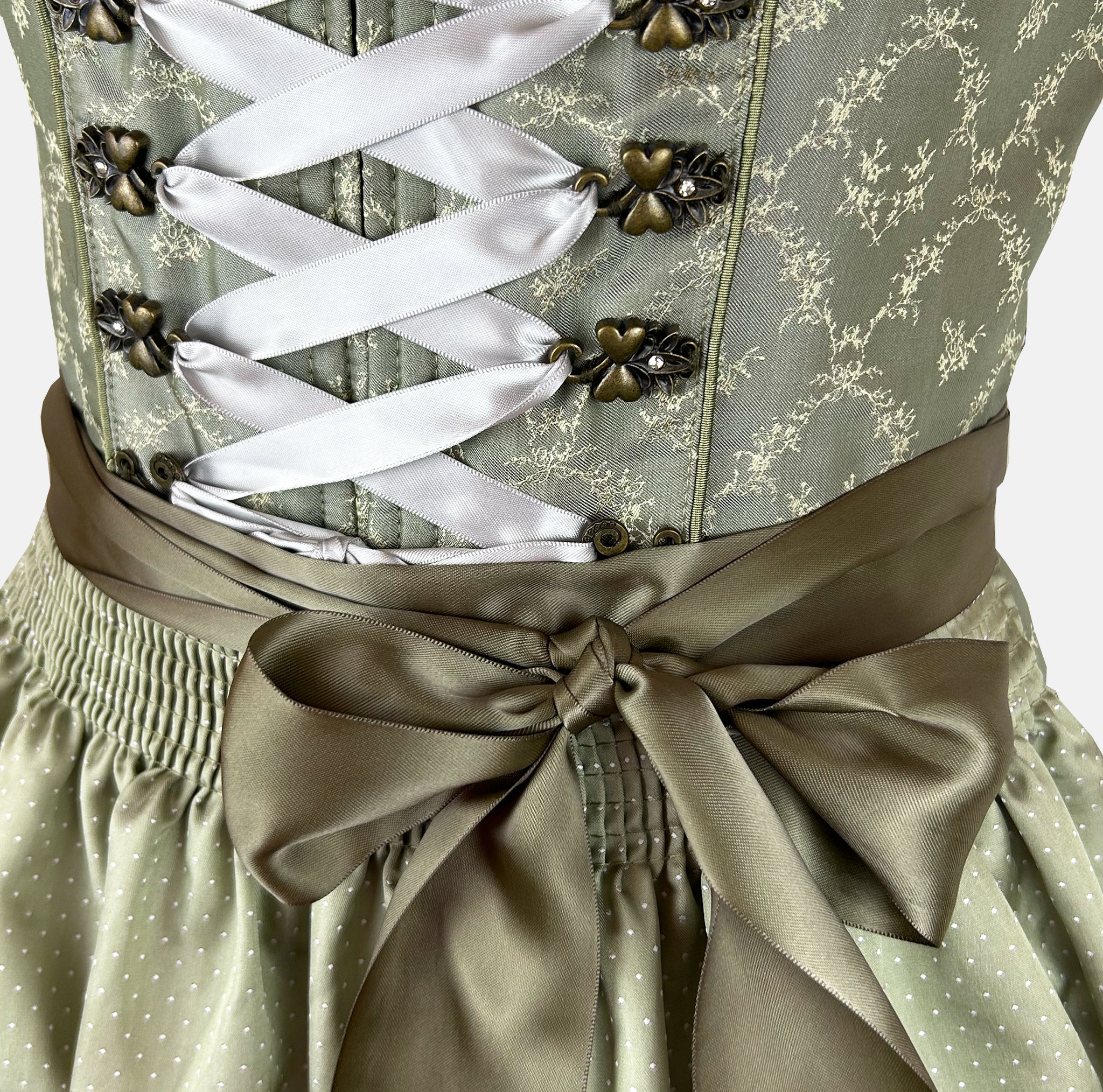 Green Krüger dirndl with lace-up bodice and 60 cm skirt – modern, stylish, and available for rent via Versatile.