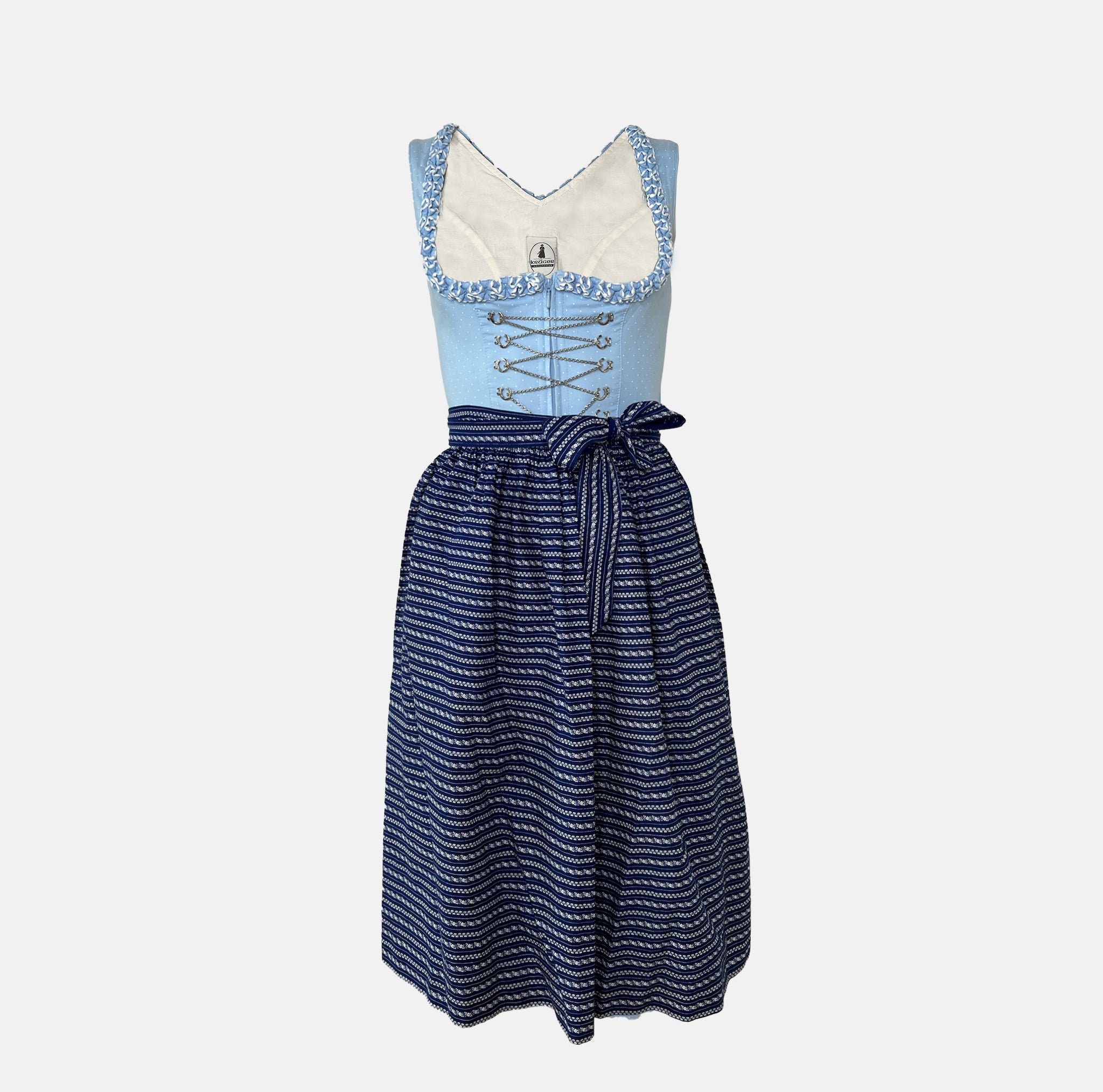 Classic light blue and navy Krüger Dirndl with lace-trimmed neckline and patterned apron – available for rent via Versatile.