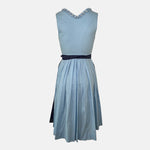 Back: Classic light blue and navy Krüger Dirndl with lace-trimmed neckline and patterned apron – available for rent via Versatile.