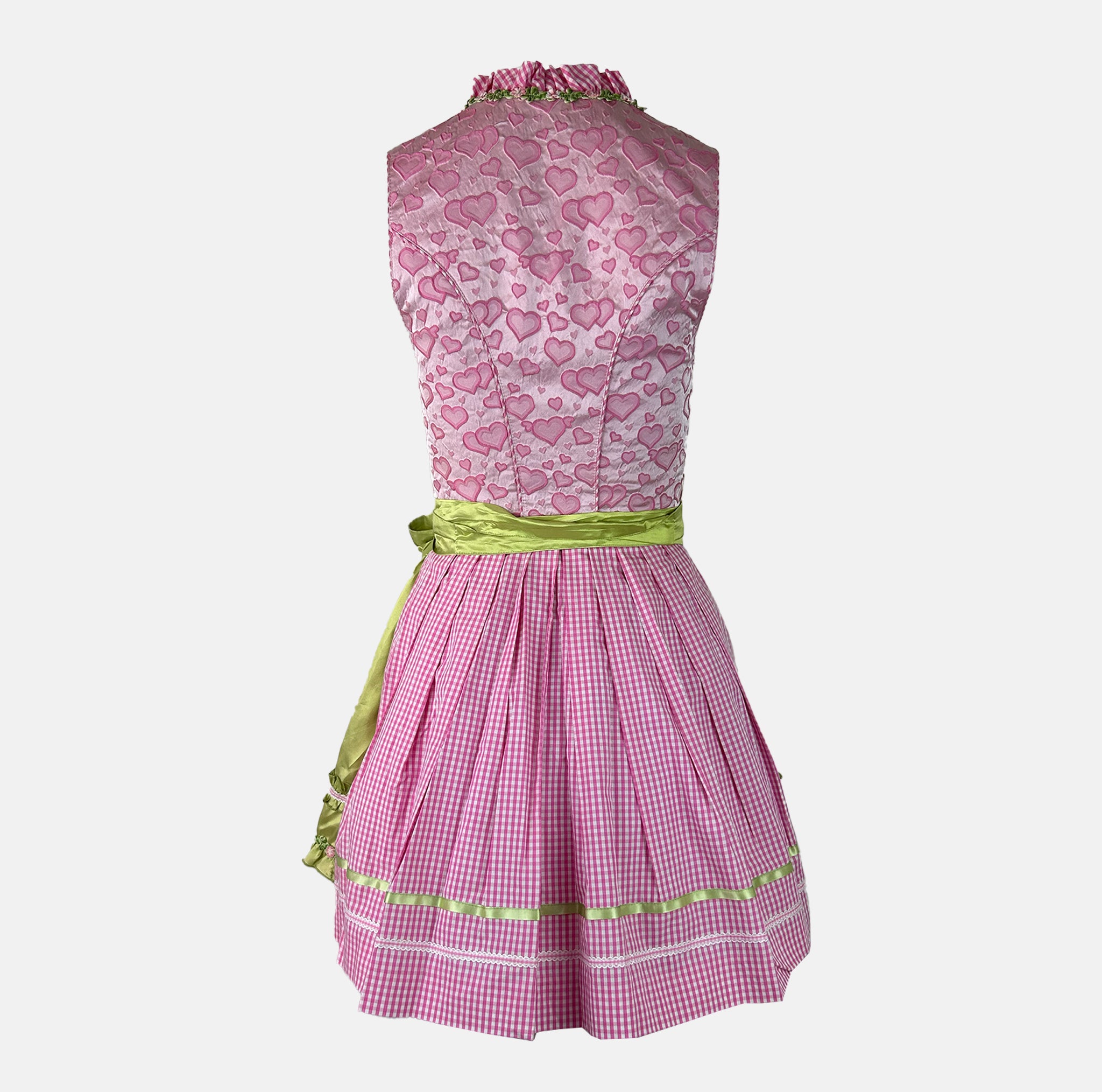 Krüger Madl dirndl with a pink heart-print bodice, green floral-trimmed apron, and pink gingham accents – playful and vibrant.
