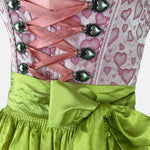 Krüger Madl dirndl with a pink heart-print bodice, green floral-trimmed apron, and pink gingham accents – playful and vibrant.
