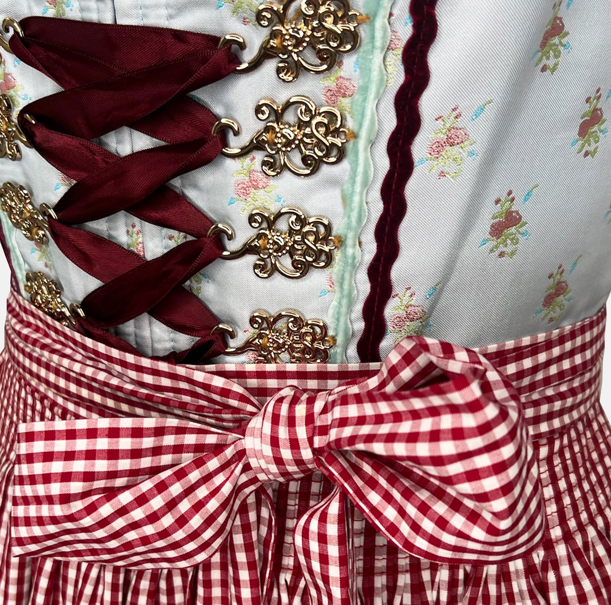 Dirndl dress by Krüger Madl featuring a light blue floral bodice, red gingham apron, and 60cm skirt with lace and ribbon accents.