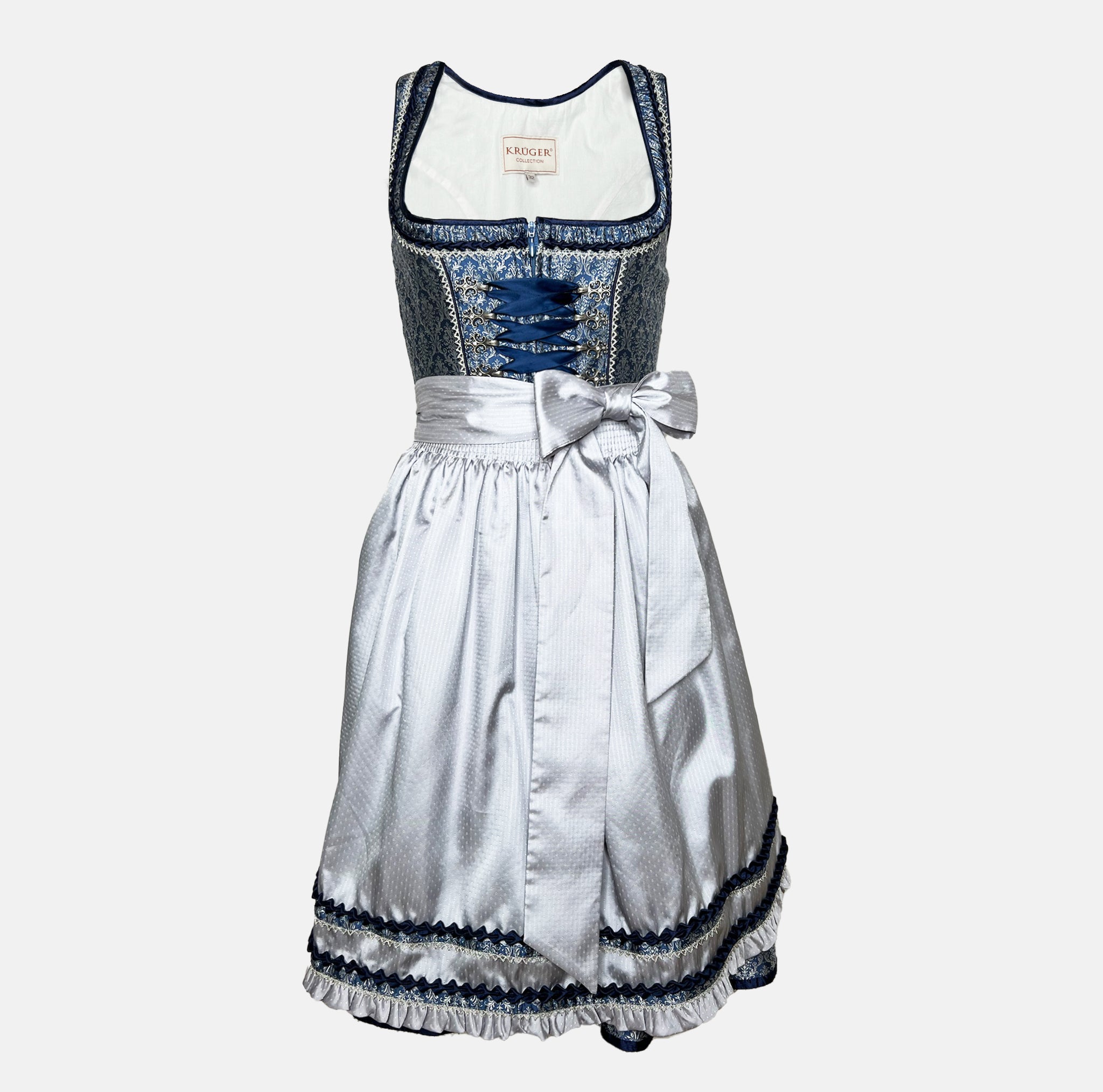 Elegant blue Krüger dirndl with silver apron, brocade bodice, and decorative lace details – available for rent at Versatile.
