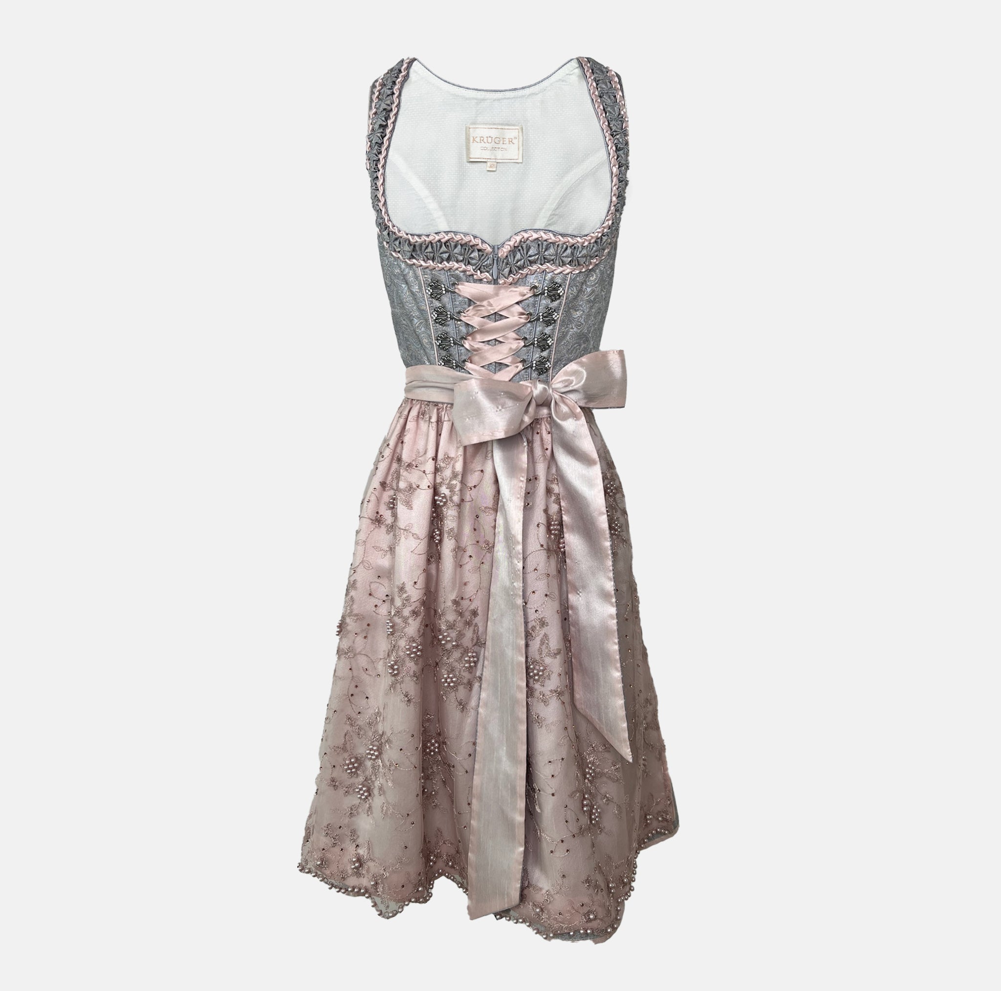 Krüger Dirndl with dusty blue bodice and pink embroidered apron. Available to rent on Versatile. Romantic, detailed, and perfect for Oktoberfest.